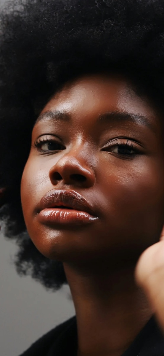 A Thea member, photographed in warm light, looking at the camera